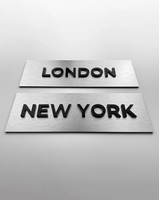 Custom brushed silver door sign with black acrylic lettering by ALUMADESIGNCO, elegant plaque for offices, meeting rooms, and contemporary interiors