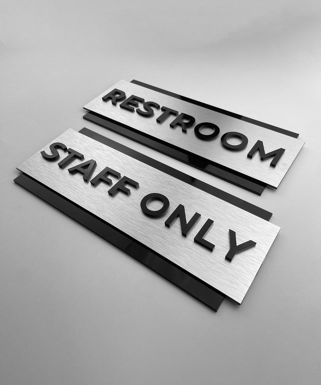 Custom brushed silver and black acrylic door sign by ALUMADESIGNCO for staff only, office, restroom, and facility signage, modern wayfinding plaque for interiors