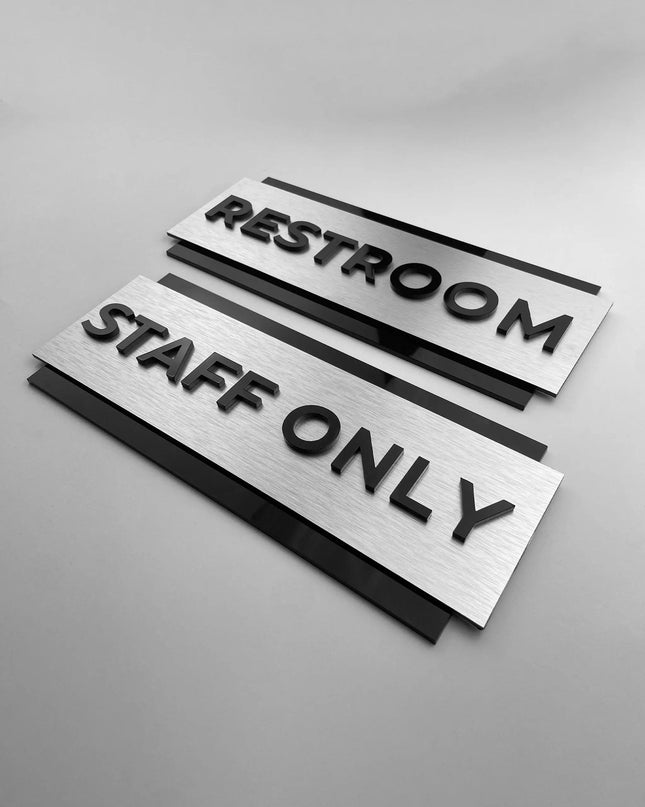 Custom brushed silver and black acrylic door sign by ALUMADESIGNCO for staff only, office, restroom, and facility signage, modern wayfinding plaque for interiors