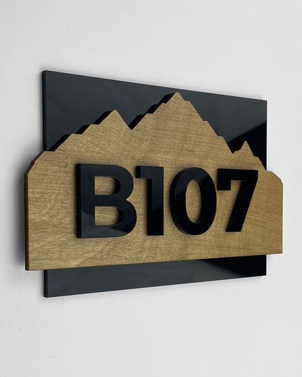 ALUMADESIGNCO wood and acrylic hotel room number sign Alpine Design with minimalist Scandinavian style, birch wood background and black acrylic 3D numbers for modern hotel and Airbnb door signage