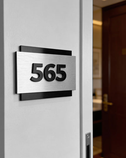 Modern room number sign by ALUMADESIGNCO combining brushed metal panel and acrylic numbers, elegant door signage for hotel corridors and apartments