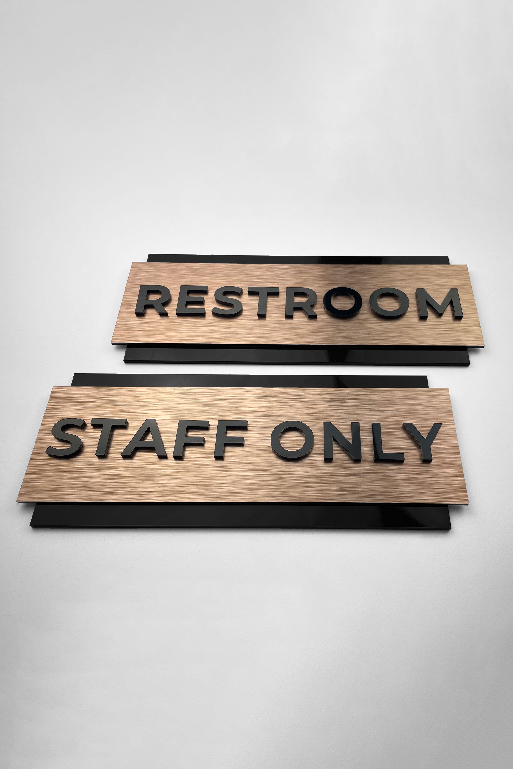Modern personalized office door sign by ALUMADESIGNCO combining bronze metal panel and acrylic text, stylish signage for offices and interior spaces