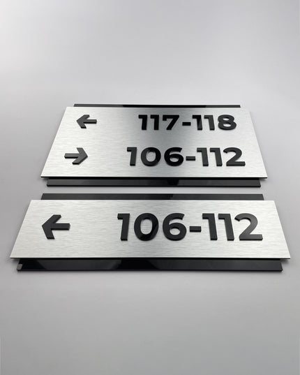 Premium custom directional wall sign by ALUMADESIGNCO featuring brushed silver plaque and black acrylic lettering, modern signage for corridors, lobbies, and interior spaces