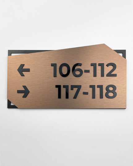 Brushed bronze and black acrylic wayfinding wall sign by ALUMADESIGNCO, elegant directional plaque for hotels, offices, corridors, and contemporary interior spaces