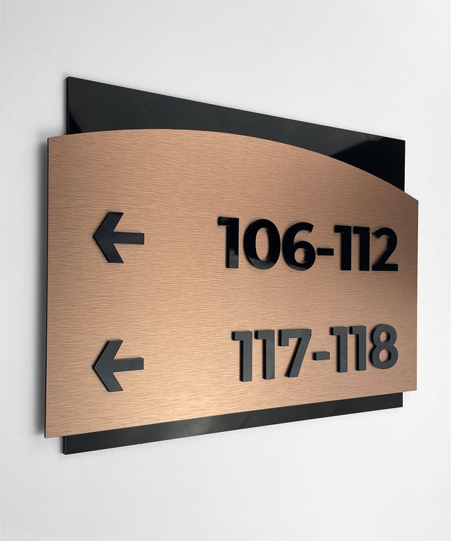 Modern Flow Design interior wayfinding sign by ALUMADESIGNCO combining brushed bronze metal panel and acrylic text, premium directional signage for interior spaces