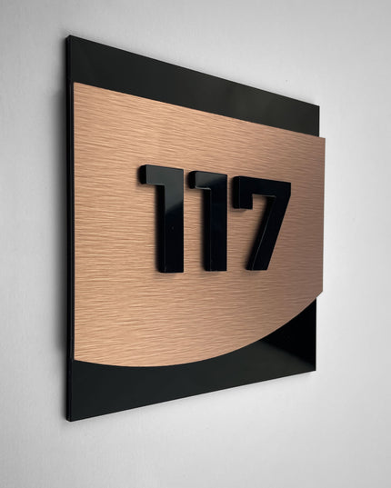 Modern bronze room number sign Flow Design by ALUMADESIGNCO featuring metal plaque and acrylic numbers, elegant door signage for hotel rooms and apartment interiors
