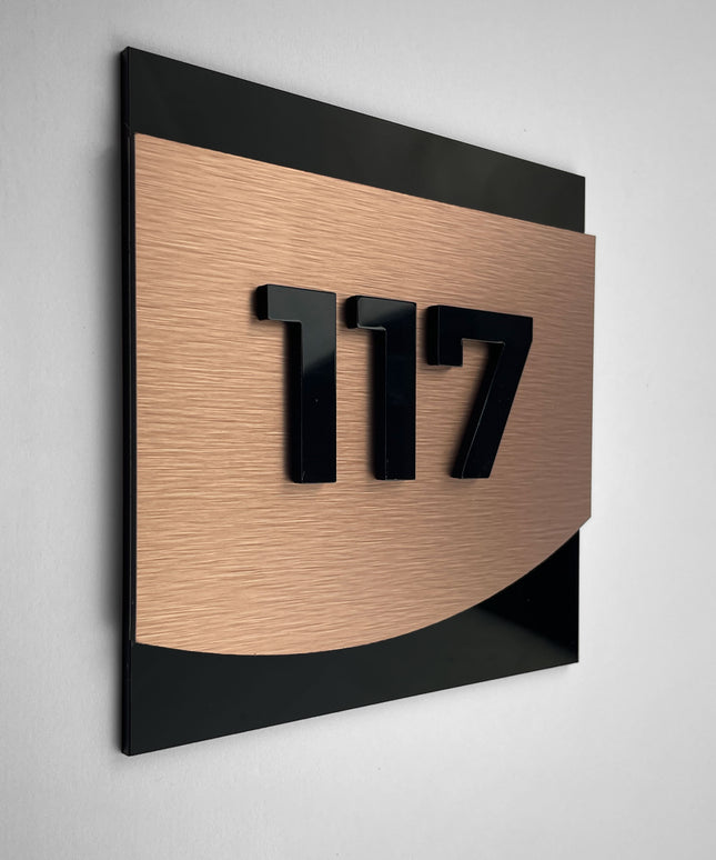 Modern bronze room number sign Flow Design by ALUMADESIGNCO featuring metal plaque and acrylic numbers, elegant door signage for hotel rooms and apartment interiors