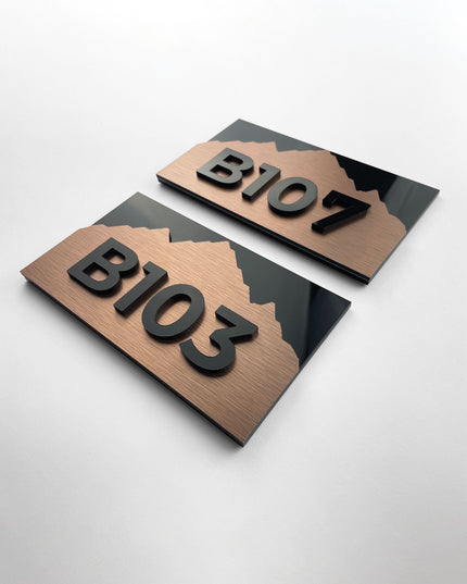 Modern Alpine Design suite number sign by ALUMADESIGNCO combining bronze metal panel and acrylic glass numbers, elegant door signage for hospitality interiors