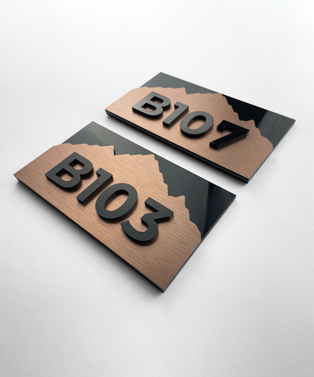 Modern Alpine Design suite number sign by ALUMADESIGNCO combining bronze metal panel and acrylic glass numbers, elegant door signage for hospitality interiors