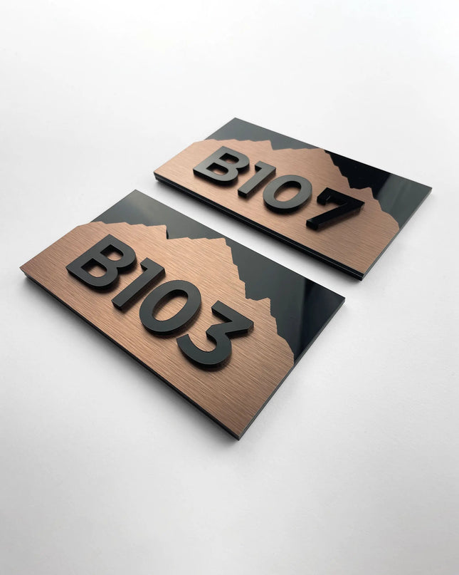Modern Alpine Design suite number sign by ALUMADESIGNCO combining bronze metal panel and acrylic glass numbers, elegant door signage for hospitality interiors