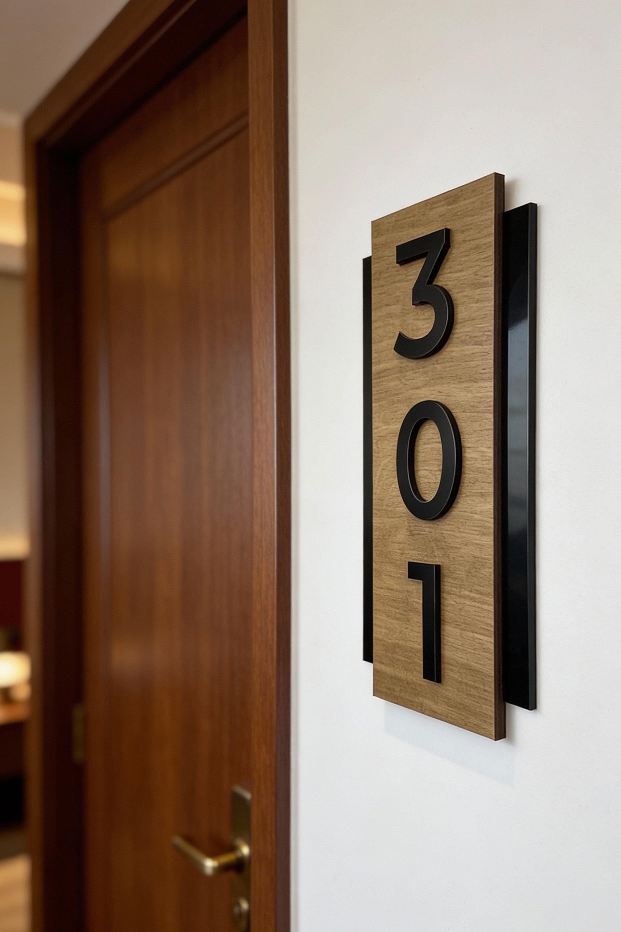 Premium vertical hotel door number sign by ALUMADESIGNCO featuring natural birch wood base and precision cut black acrylic numbers, modern Scandinavian signage for hotel corridors and apartment buildings