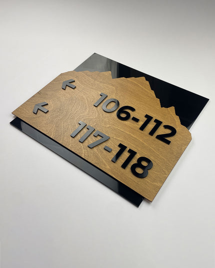 Premium Alpine directional wall sign by ALUMADESIGNCO featuring birch wood plate and black acrylic lettering, modern wayfinding signage for hospitality and office interiors