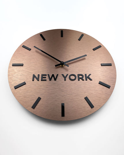 Modern brushed bronze world time zone clock by ALUMADESIGNCO with personalized city name displays, premium wall décor for offices and hospitality spaces
