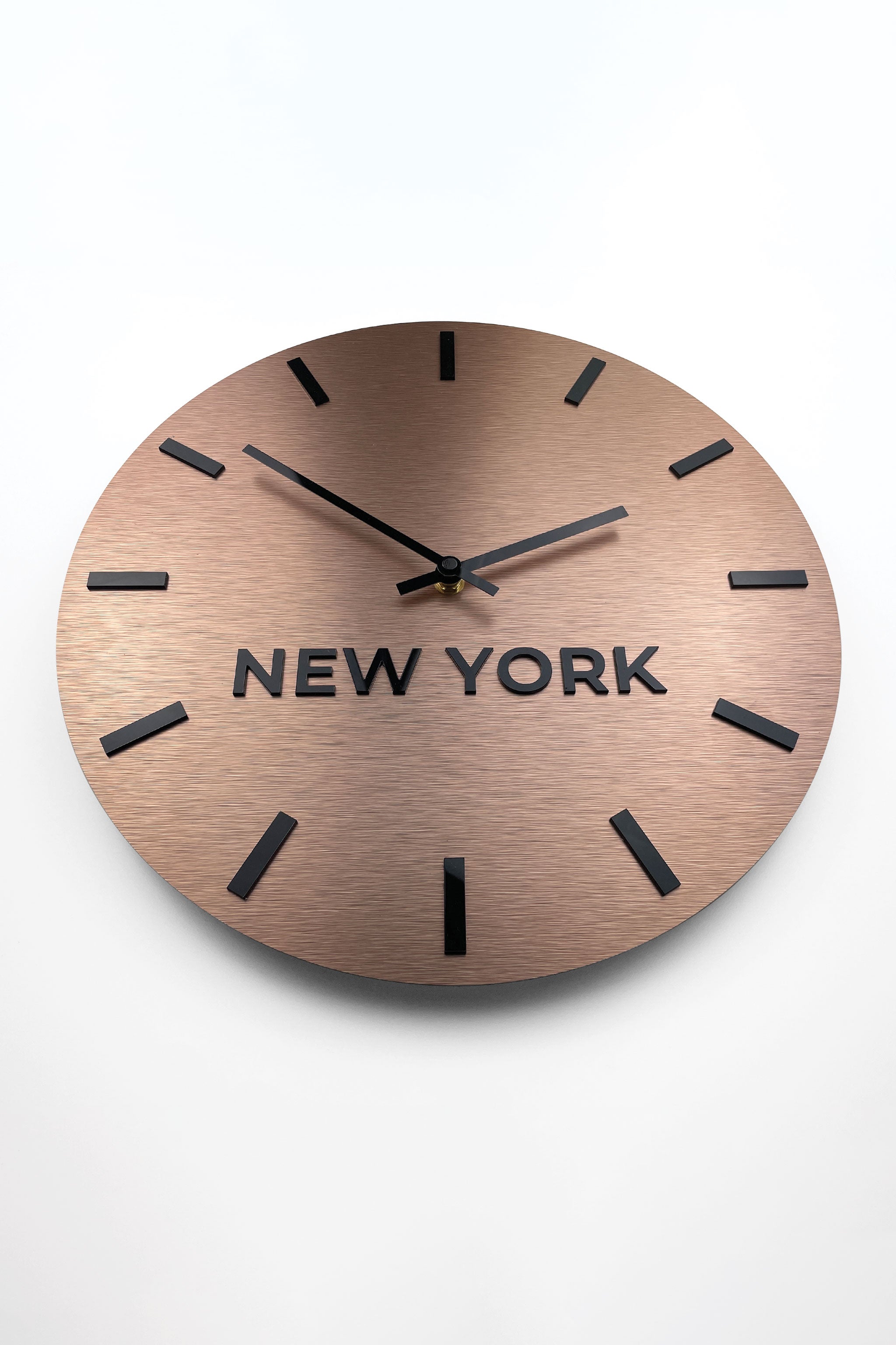 Modern brushed bronze world time zone clock by ALUMADESIGNCO with personalized city name displays, premium wall décor for offices and hospitality spaces