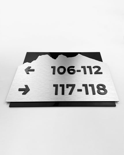 Premium directional wall sign by ALUMADESIGNCO featuring brushed silver plaque and black acrylic lettering, modern wayfinding signage for hospitality and office interiors
