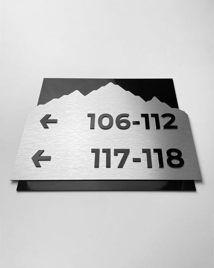 Premium Alpine directional wall sign by ALUMADESIGNCO featuring brushed silver plate and black acrylic lettering, modern wayfinding signage for hospitality and office interiors
