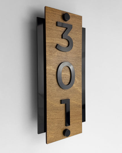 Standoff vertical hotel room number sign by ALUMADESIGNCO crafted from birch plywood with raised black acrylic numbers, modern wood and acrylic signage with steel standoff mounting for hotels and offices
