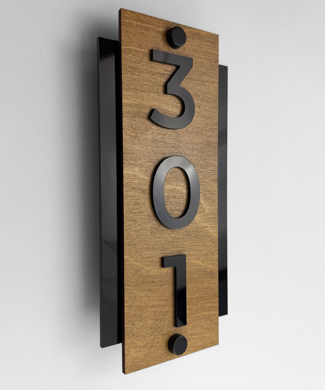Standoff vertical hotel room number sign by ALUMADESIGNCO crafted from birch plywood with raised black acrylic numbers, modern wood and acrylic signage with steel standoff mounting for hotels and offices