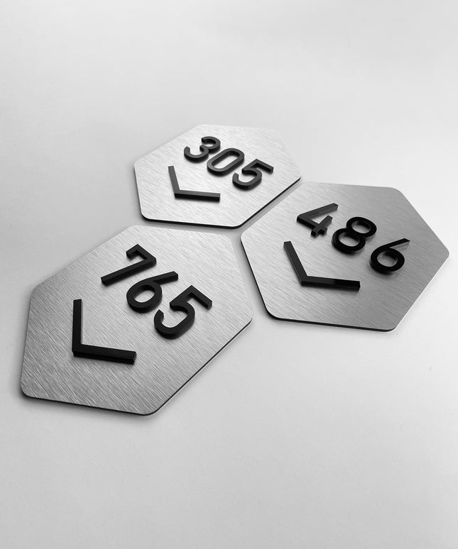 Custom silver and acrylic room number sign Hexagon Design by ALUMADESIGNCO featuring geometric style and raised acrylic numbers for hotel rooms and apartment doors