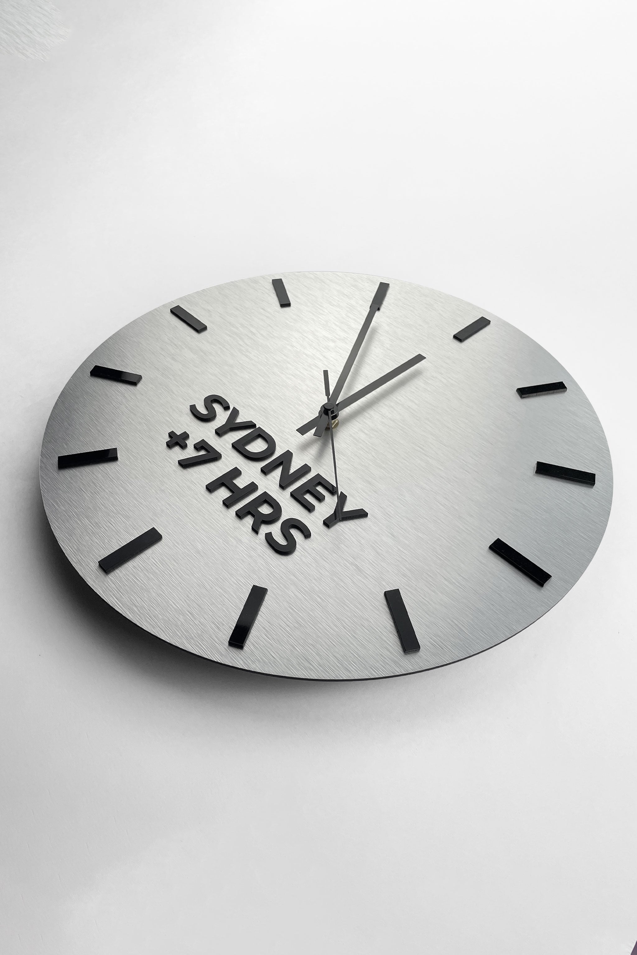 Modern brushed silver world time zone clock by ALUMADESIGNCO with personalized city names, stylish office wall clock for business interiors and hospitality spaces