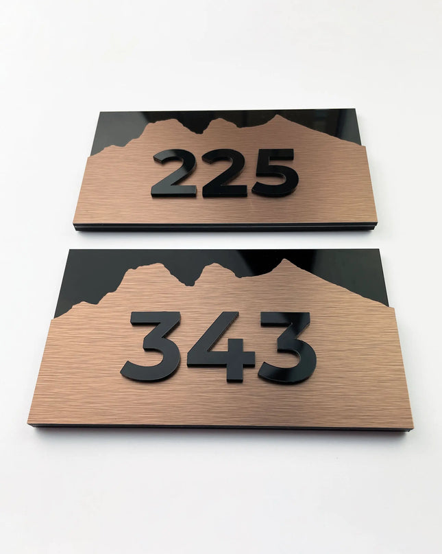 Modern Alpine Design high-end room number sign by ALUMADESIGNCO combining brushed bronze metal panel and acrylic numbers, elegant door signage for contemporary interiors