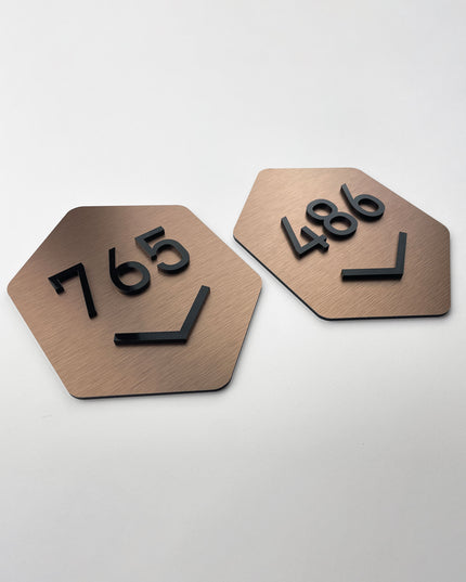 ALUMADESIGNCO brushed bronze hexagon door number sign with minimalist modern design, premium signage for boutique hotels and apartment buildings