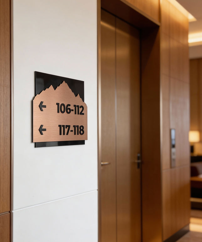 ALUMADESIGNCO Alpine Design directional sign with brushed bronze plaque and black acrylic text, premium wayfinding signage for offices, hotels, apartments, and commercial interiors