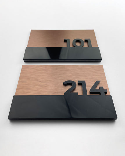Brushed bronze and acrylic glass suite room sign by ALUMADESIGNCO, elegant door signage for hotel suites, apartments, and contemporary interiors
