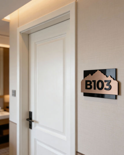 Modern Alpine Design bronze room number sign by ALUMADESIGNCO combining brushed bronze metal panel and acrylic numbers, stylish door signage for contemporary interiors