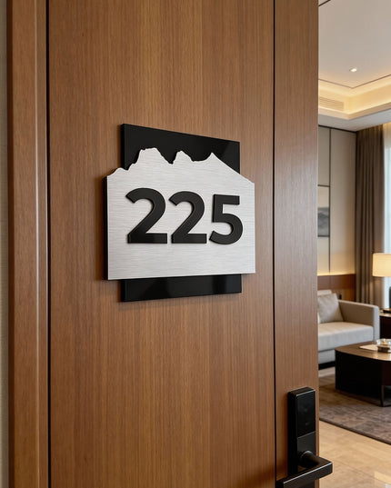 Modern Alpine hotel door number plaque by ALUMADESIGNCO made from brushed silver aluminum and raised black acrylic numbers, elegant signage for hotel rooms and corridors