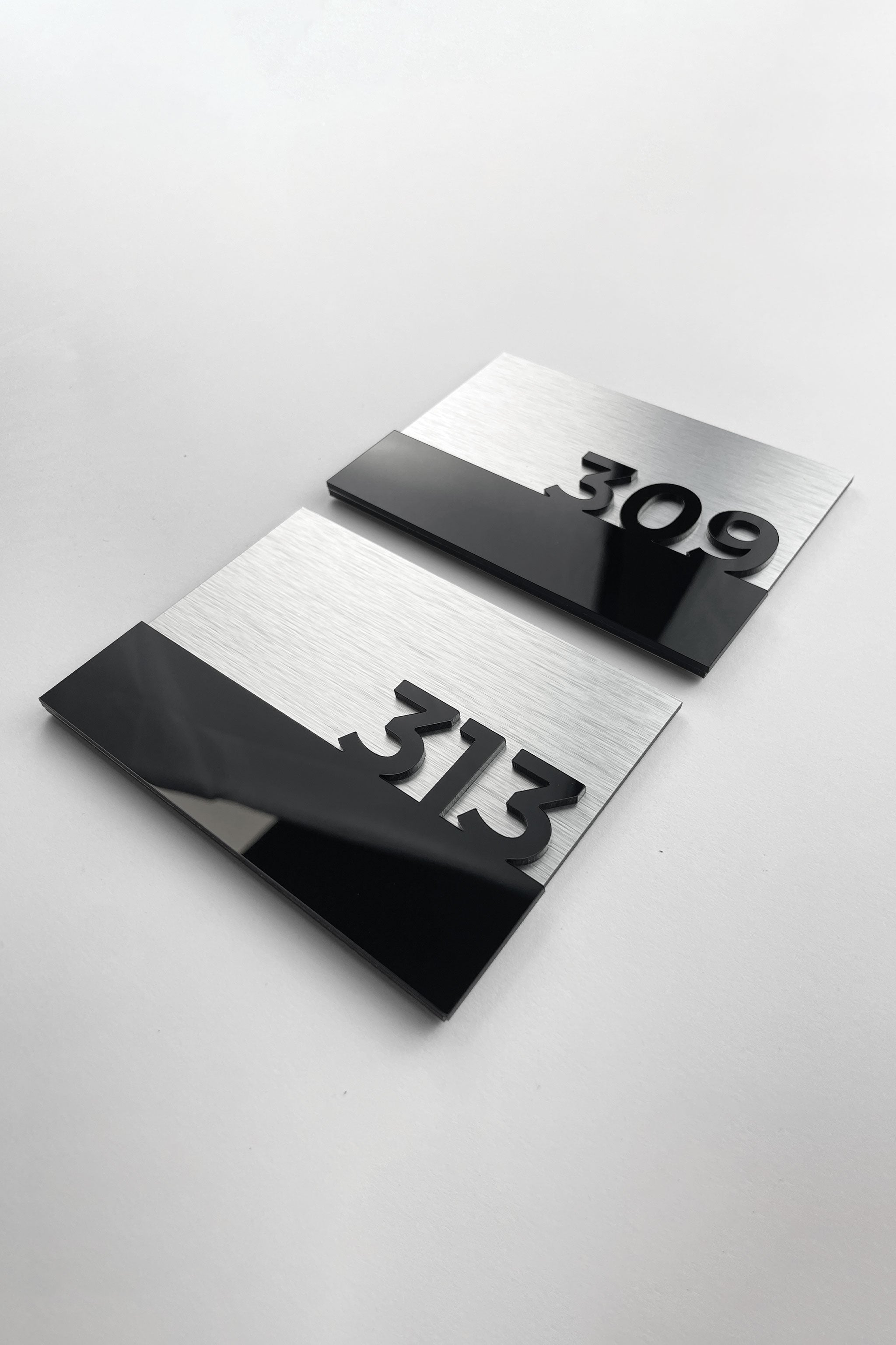 Elegant silver metal and black acrylic hotel room number sign by ALUMADESIGNCO, premium door plaque for hotel corridors and contemporary interiors