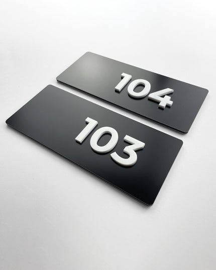 ALUMADESIGNCO custom black metal and white acrylic suite number sign with minimalist modern design, premium signage for boutique hotels and apartment buildings