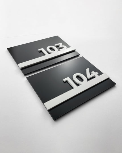 Black metal and white acrylic hotel room number sign by ALUMADESIGNCO, modern door plaque for hotel corridors and contemporary interiors