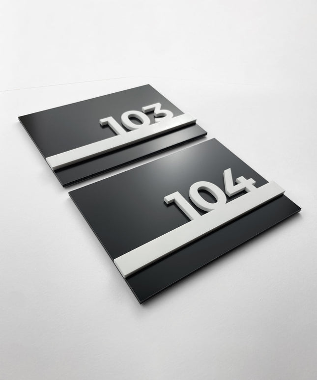 Black metal and white acrylic hotel room number sign by ALUMADESIGNCO, modern door plaque for hotel corridors and contemporary interiors