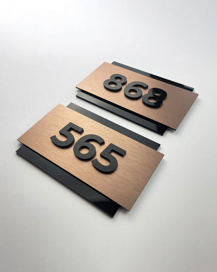 Premium brushed bronze hotel room number sign by ALUMADESIGNCO featuring raised acrylic numbers, modern door signage for hotels and contemporary interiors