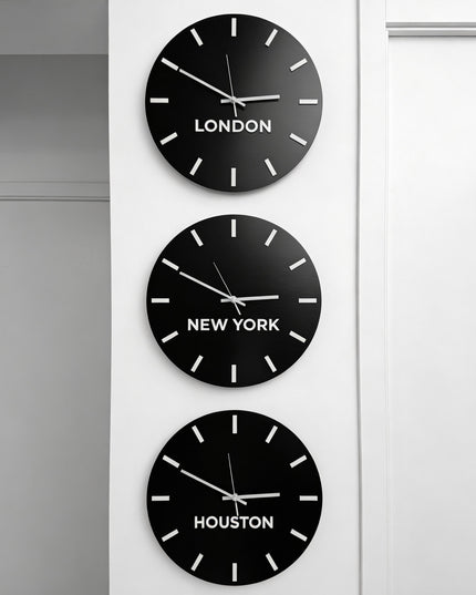 Brushed black personalized world time zone clock with white acrylic glass city name plates by ALUMADESIGNCO, premium wall décor for studios, offices, hotels, and corporate interiors