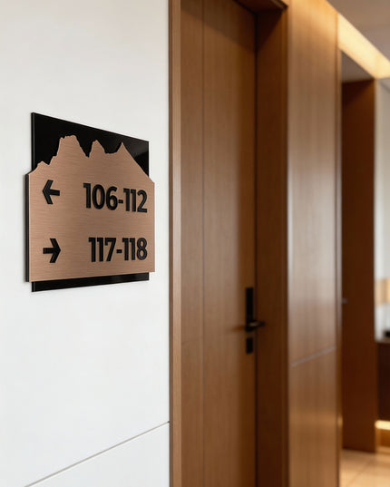 Modern Alpine Design directional sign by ALUMADESIGNCO combining brushed bronze metal plaque and acrylic text, premium wayfinding signage for hotels, offices, and contemporary interiors