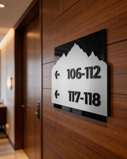 Modern Alpine Design wayfinding sign by ALUMADESIGNCO combining brushed silver metal panel and black acrylic text, premium directional signage for hotels, offices, and contemporary interiors