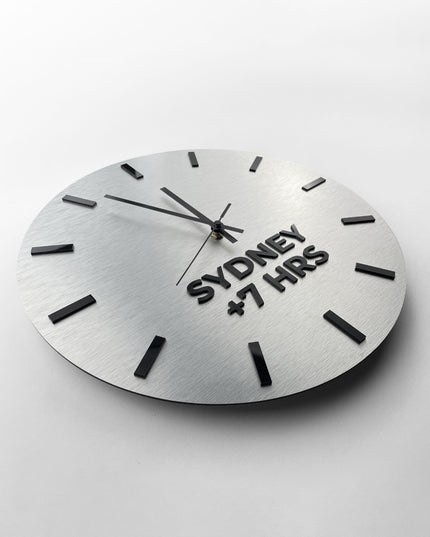 ALUMADESIGNCO brushed silver multi time zone wall clock with custom city labels, modern décor for offices, hotels, conference rooms, and interior design projects