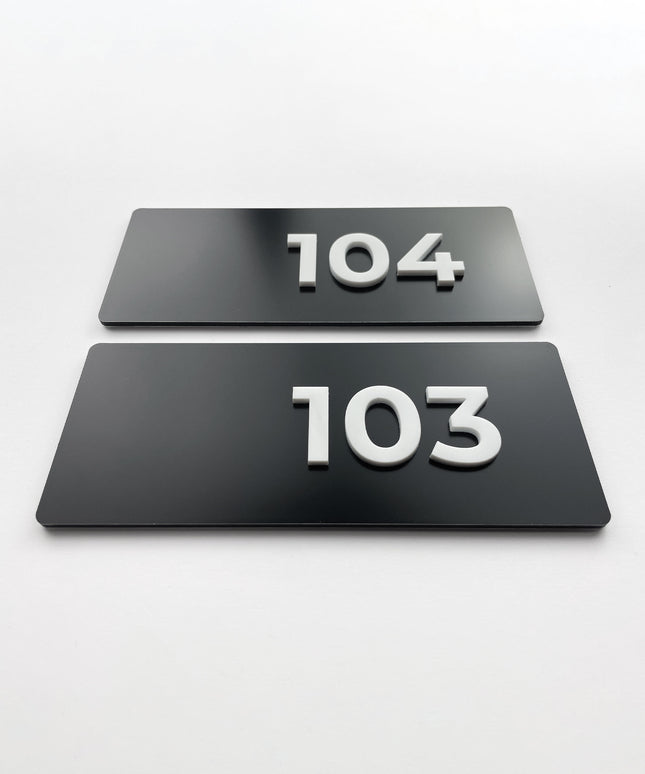 Custom black metal and white acrylic suite number sign by ALUMADESIGNCO, modern door plaque for hotel suites and contemporary interiors