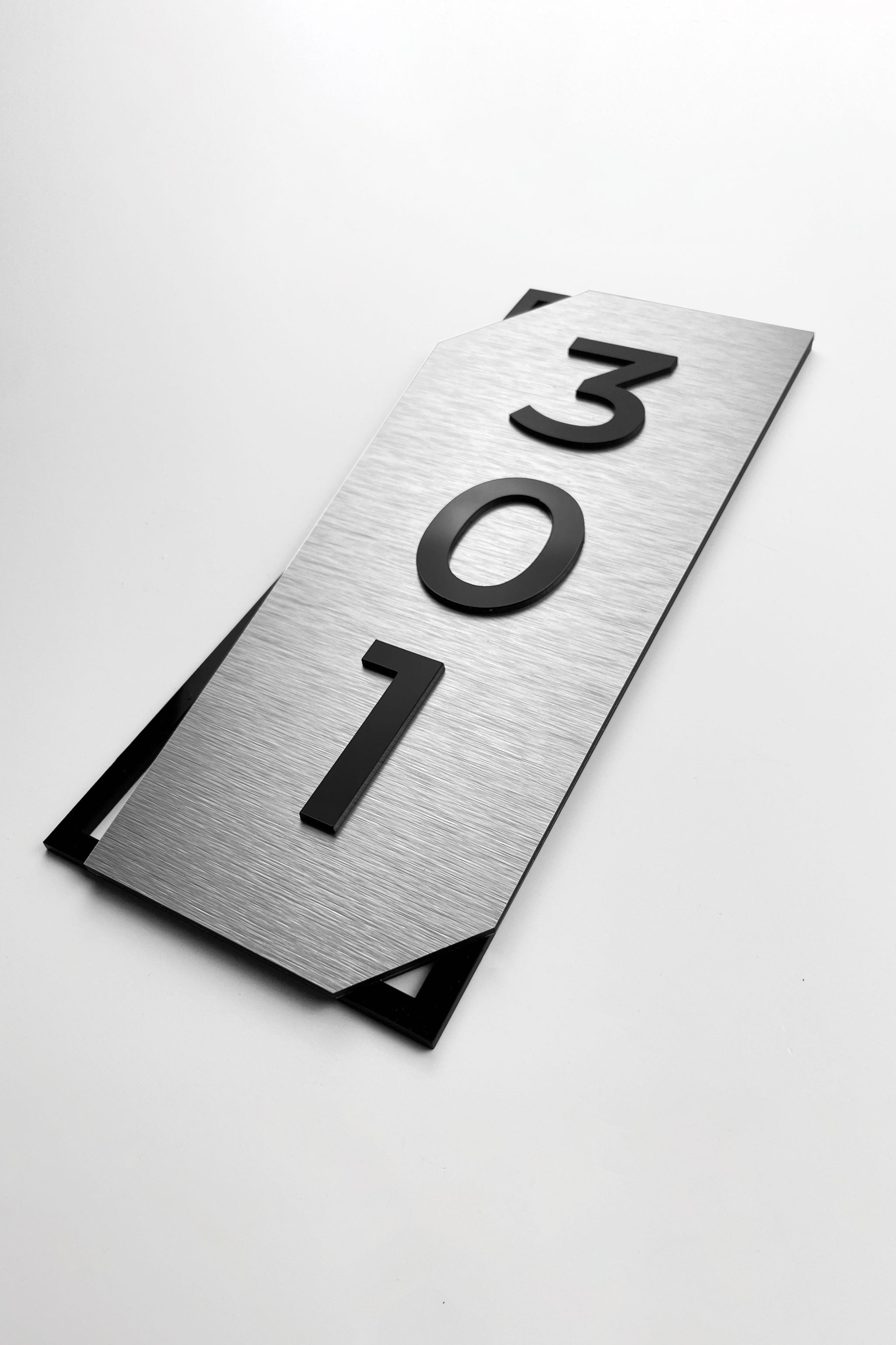 ALUMADESIGNCO vertical brushed silver door number sign with acrylic glass numbers, premium wall signage for boutique hotels and residential interiors