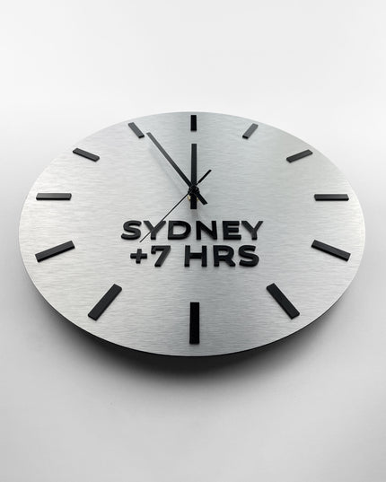 Premium brushed silver world time zone clock by ALUMADESIGNCO featuring multiple city name plaques, elegant wall clock for offices, reception areas, and modern spaces