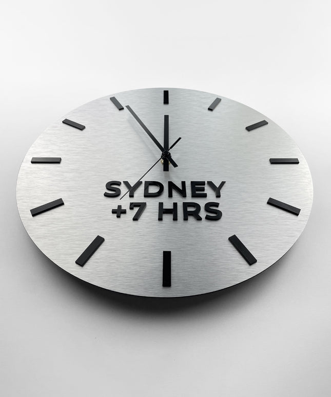 Premium brushed silver world time zone clock by ALUMADESIGNCO featuring multiple city name plaques, elegant wall clock for offices, reception areas, and modern spaces