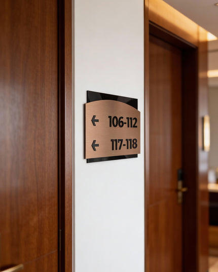 Premium Flow interior directional wall sign by ALUMADESIGNCO featuring brushed bronze plaque and acrylic lettering, modern wayfinding signage for hospitality and office interiors