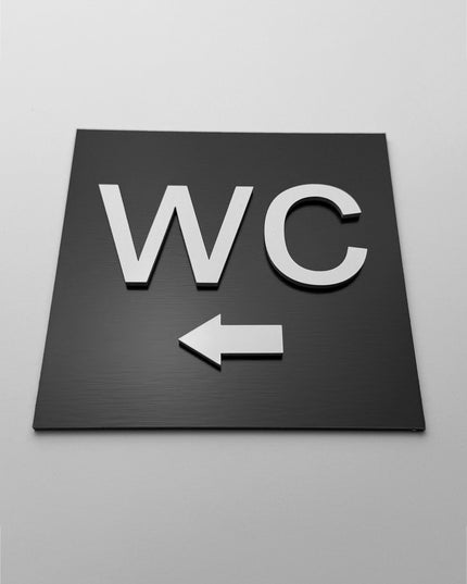 ALUMADESIGNCO toilet direction sign for doors and walls with left arrow, premium restroom wayfinding signage for offices, hotels, apartments, and commercial spaces