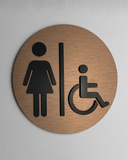 ALUMADESIGNCO accessible women’s bathroom door sign with minimalist modern style, female and wheelchair signage for offices, hotels, cafés, and contemporary interiors