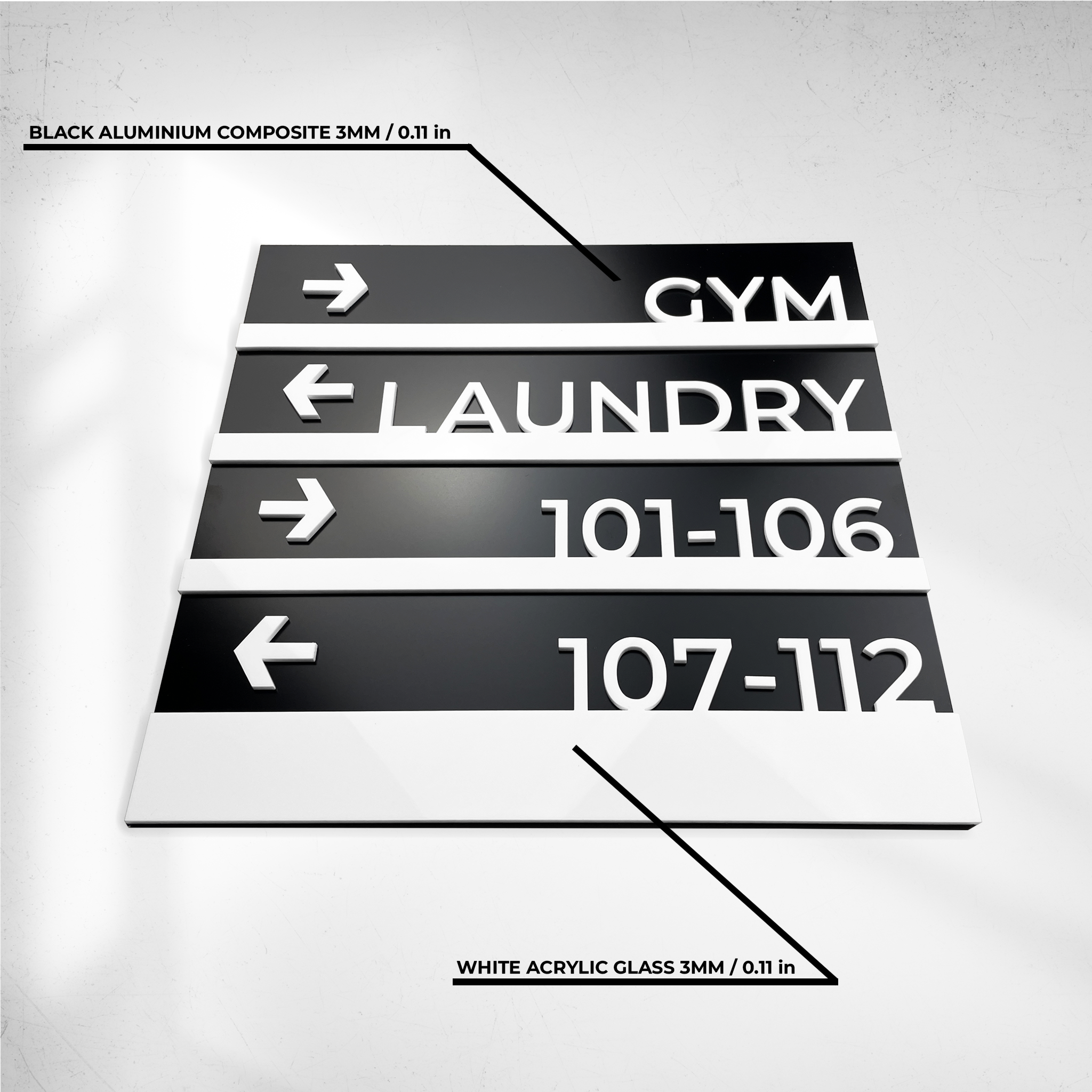 Custom-sized hotel wayfinding sign for spa and gym in sophisticated black and white design