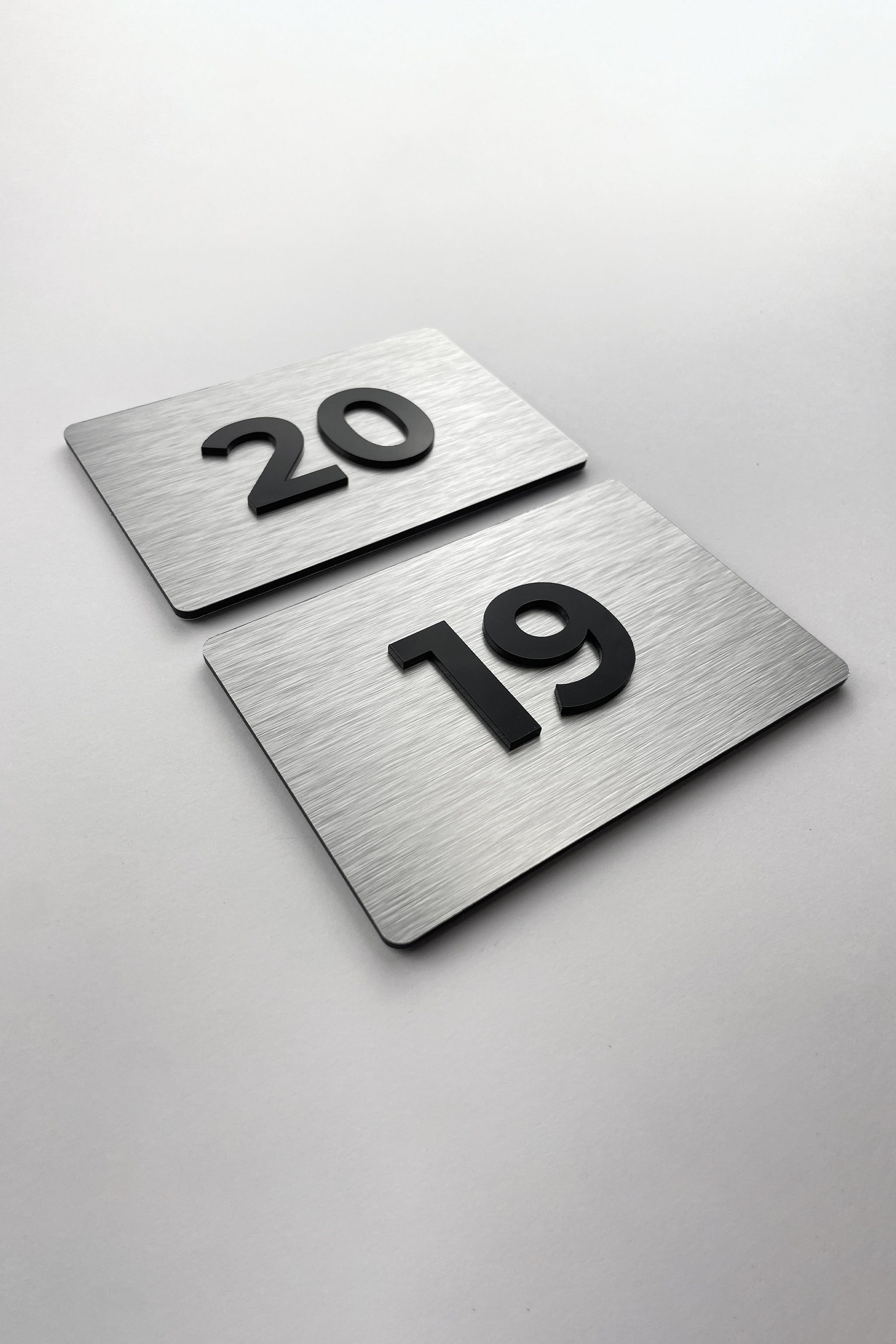 Premium room number sign for doors by ALUMADESIGNCO featuring brushed silver plaque and acrylic numbers, elegant door signage for hotels and offices