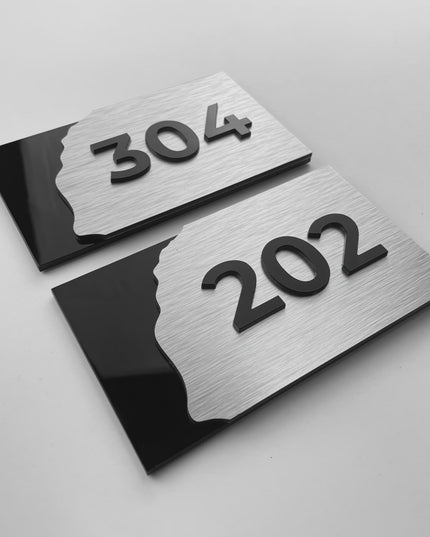 Modern hotel door number sign in brushed silver and acrylic by ALUMADESIGNCO, stylish signage for hotel rooms, offices, and residential interiors