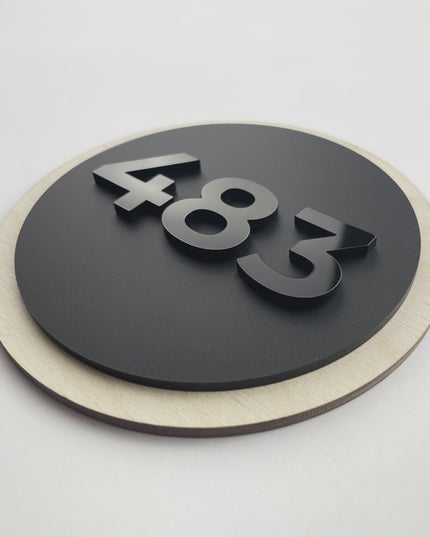 ALUMADESIGNCO wood and acrylic glass round hotel room number sign with minimalist Scandinavian design, birch wood base and black acrylic numbers for modern hotel interiors